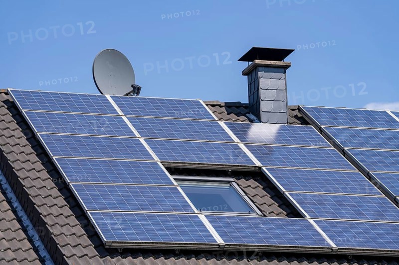Solar system on the pitched roof of a residential building, photovoltaics for power generation, for own consumption and grid feed-in, North Rhine-Westphalia, Germany, Europe