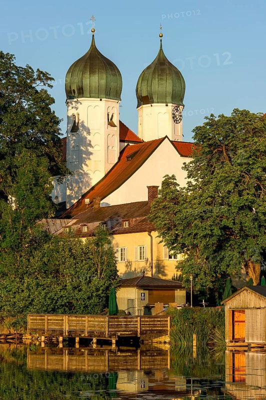 Romanesque Benedictine Abbey Seeon Monastery, monastery church St. Lambert with reflection in the monastery lake, calm smooth water in the evening light at sunset, Seeon-Seebruck, Chiemgau, Upper Bavaria, Bavaria, Germany, Europe