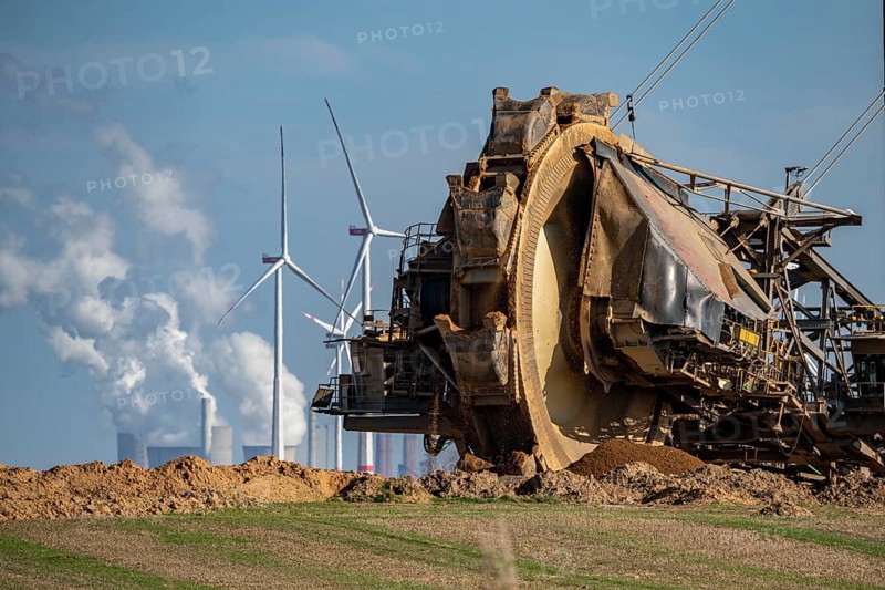 Opencast lignite mine Garzweiler II, bucket wheel excavator dredging, at the edge of the opencast mine near the village of Lützerath, belongs to Erkelenz in the district of Heinsberg, in the background wind farm, and the lignite-fired power plant Neurath, North Rhine-Westphalia, Germany, Europe