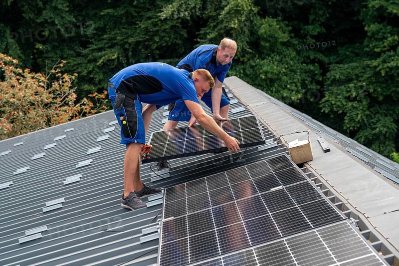 Installation of solar modules on the roof of a barn on a farm, over 240 photovoltaic modules are installed on the roof, North Rhine-Westphalia, Germany, Europe