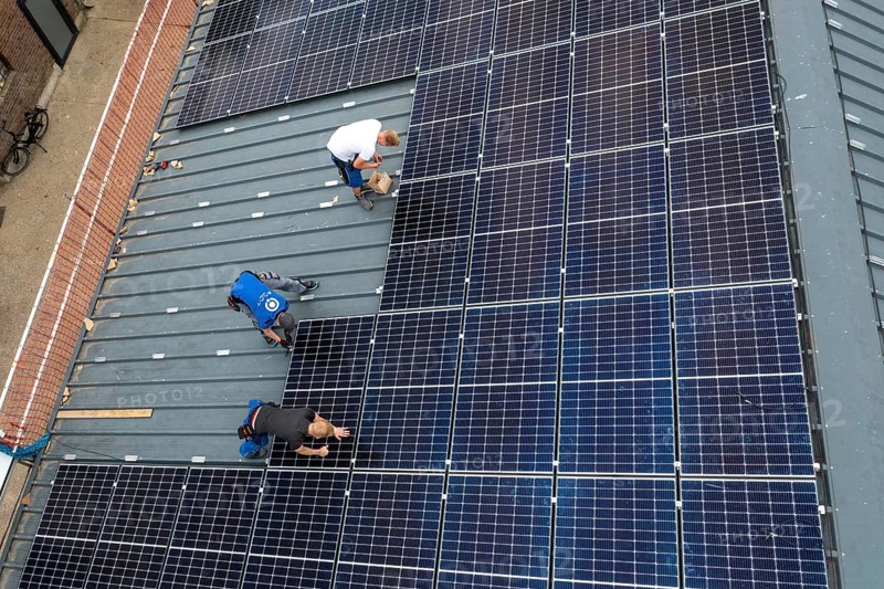 Installation of solar modules on the roof of a barn on a farm, over 210 photovoltaic modules are installed on the roof, North Rhine-Westphalia, Germany, Europe