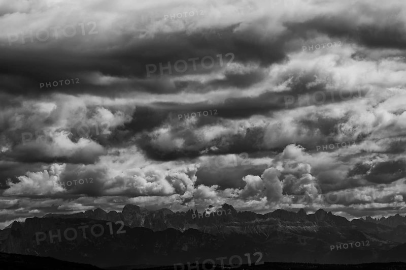 View from the panoramic path on the Vigiljoch to the rose garden mountain range, Dolomites, dramatic clouds, black and white, near Lana, South Tyrol, Autonomous Province of Bolzano, Italy, Europe
