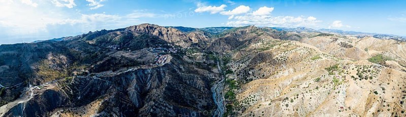 Panorama of Mountains and Olive groves around Ghost Town from a drone, Pentedattilo Village, Calabria, Italy, Europe