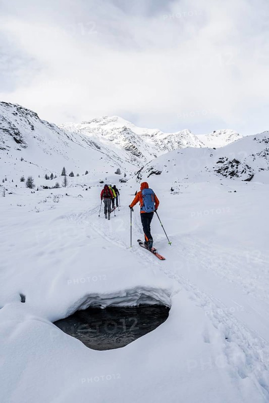 Ski tourers ascending in the rear Martell Valley, snow-covered mountain peak Monte Cevedale behind, Ortler Alps, Vinschgau Valley, Italy, Europe