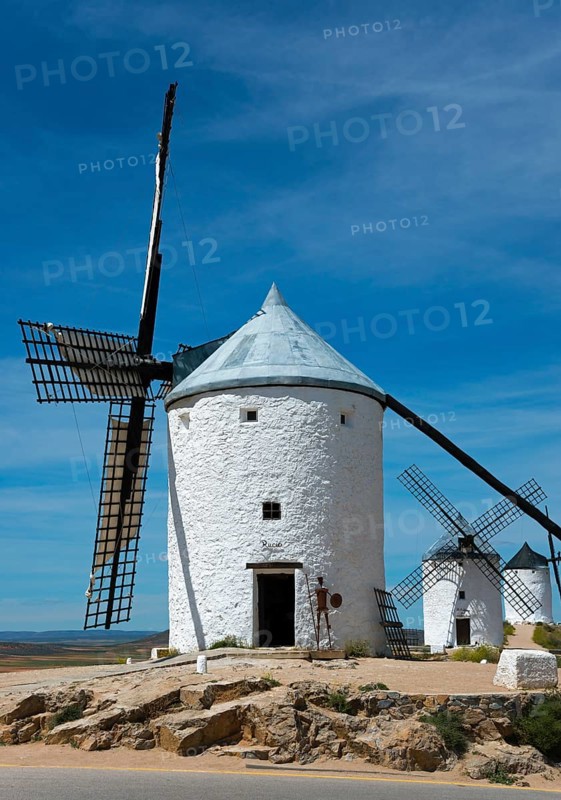 Historic white windmills with a blue sky in the background in a Spanish landscape, Consuegra, Toledo, Castilla-La Mancha, Route of Don Quixote, Spain, Europe