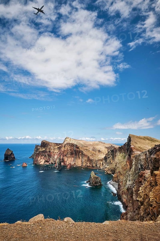 Madeira Island scenic rugged landscape, Ponta do Sao Lourenco cape with descending passenger airplane, Miradouro do Abismo viewpoint. Madeira, Portugal, Europe