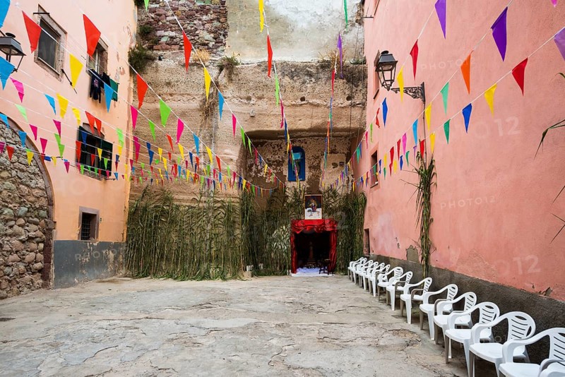 Decorated alley and colourful houses, feast of the Madonna of Regnos Altos, Bosa, district of Oristano, Sardinia, Italy, Europe