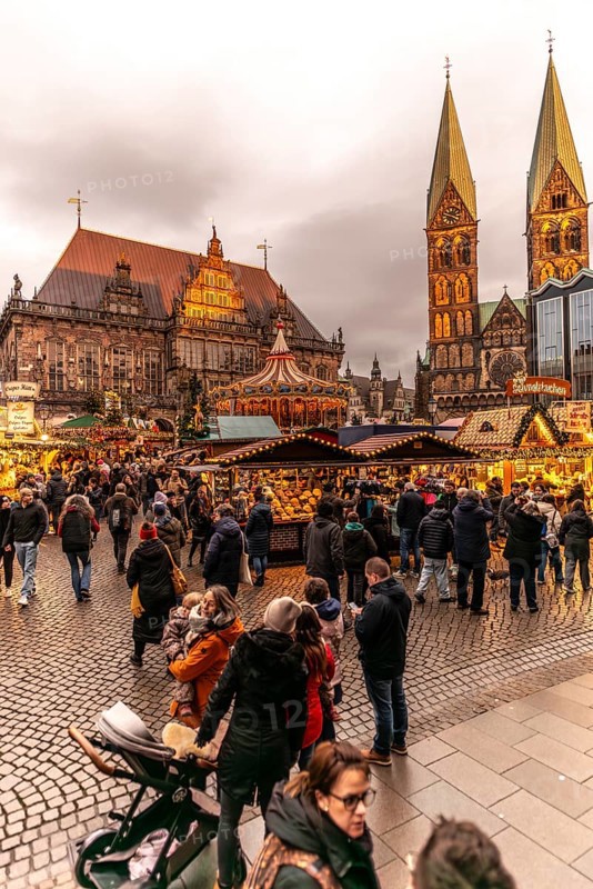 Christmas market at the historic town hall of the Hanseatic city of Bremen, market square in the old town, twin towers of the Gothic St. Peter's Cathedral, Christmas decorations, carousel, stalls, Germany, Europe