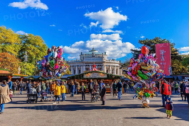 Colourful balloons and visitors at the Christmas market at City Hall, behind the Burgtheater, Vienna, Austria, Europe