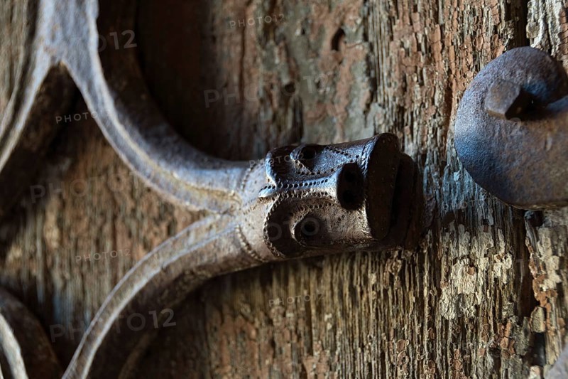 Orcival. Intricate Roman wrought iron hinge displayed at the Basilica Notre-Dame d'Orcival, Puy de dome, Auvergne-Rhone-Alpes, France, Europe