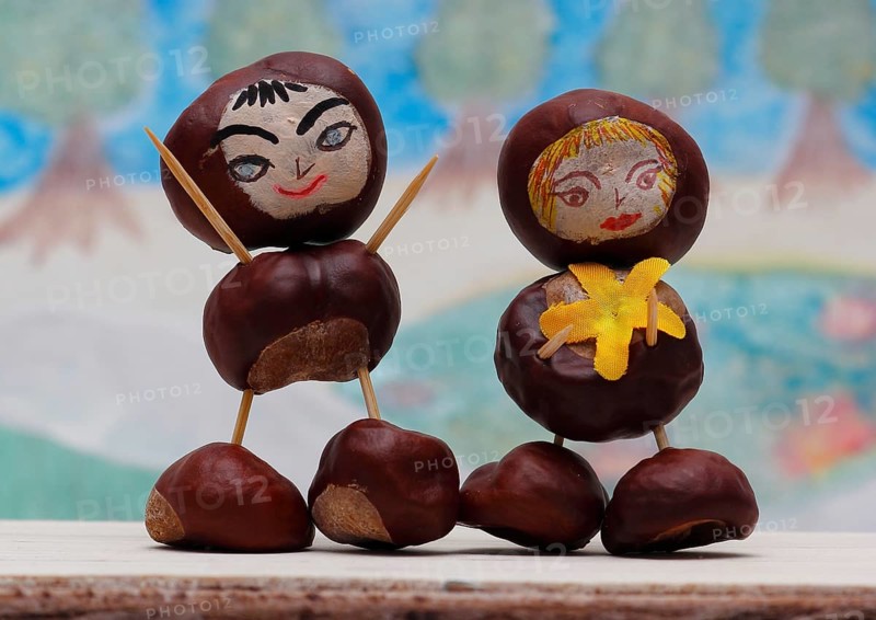 Two cute chestnut figures in front of a painted background, North Rhine-Westphalia, Germany, Europe