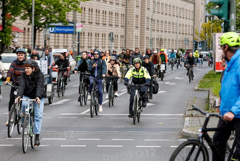 A policewoman from the Berlin bicycle squadron accompanies the bike parade demonstration, Berlin, 07 05 2023