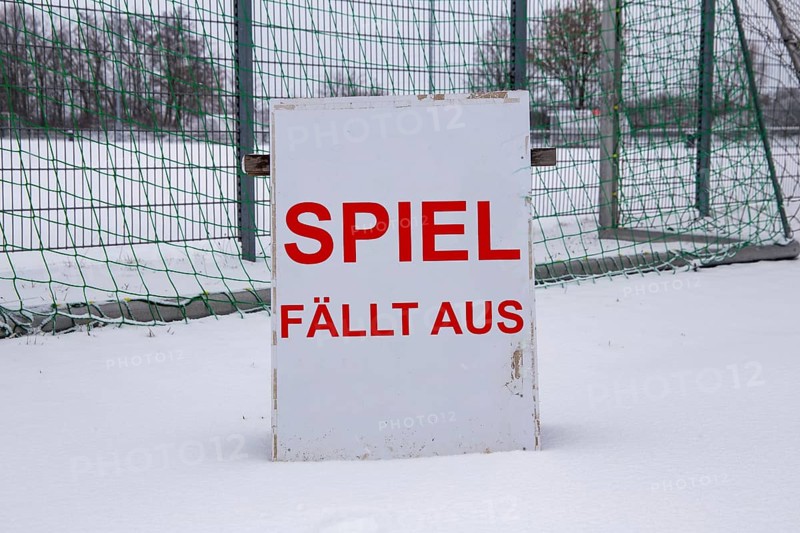 Symbolic image of a football match cancelled due to snow. Sign on a sports field with the inscription GAME CANCELLED