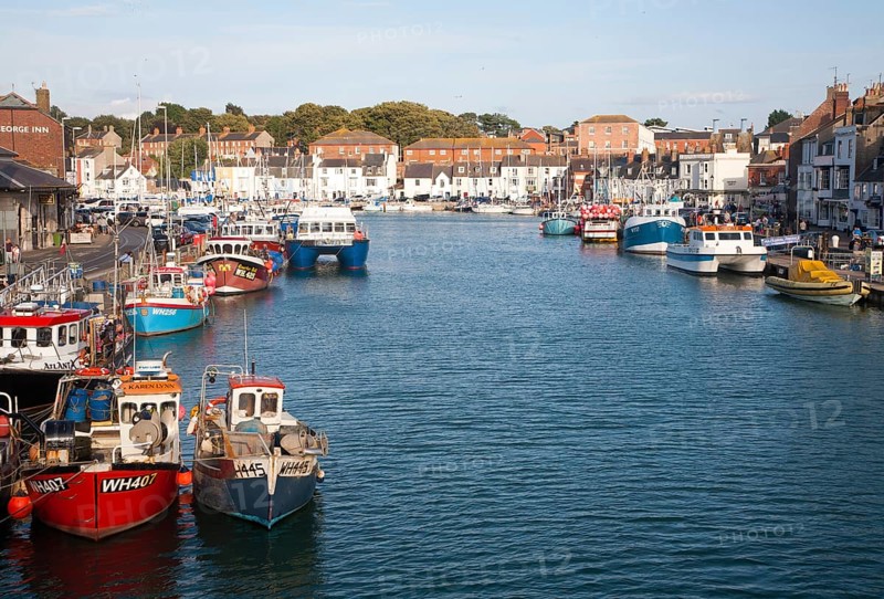 Colourful fishing boats in the harbour at Weymouth, Dorset, England, UK