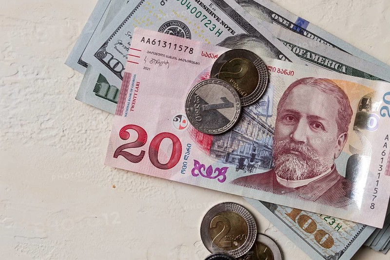 Lari, 20 GEL, Georgian monetary currency, with dollars, banknotes, top view, no people, on the table