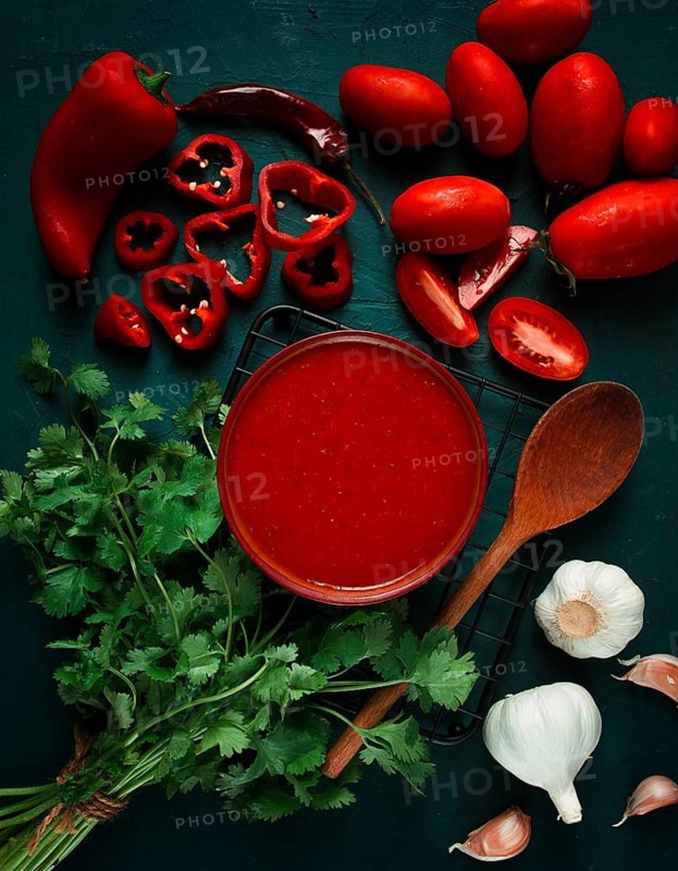 Tomato sauce, tomatoes and sweet pepper, Georgian Satsebeli sauce, with ingredients on a dark background, top view, close-up, no people