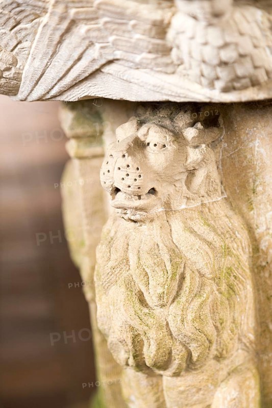 Stone carved lion animal figure support on baptismal font in village parish church, Saint John the Baptist, Butley, Suffolk, England, UK