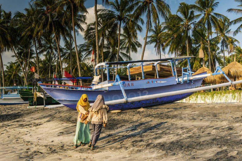 Muslim woman in the evening sun at Mangsit beach in Sengiggi, boat, fishing boat, palm beach, youth, Islam, religion, headscarf, travel, tourism, sea, ocean, island, coast, tropical, tropics, Asian, natural landscape, untouched, tourism, holiday, lonely, deserted, tranquillity, authentic, authenticity, original, atmosphere, holiday mood, long-distance travel, tradition, traditional, poverty, culture, tradition, holiday idyll, Lombok, Indonesia, Asia