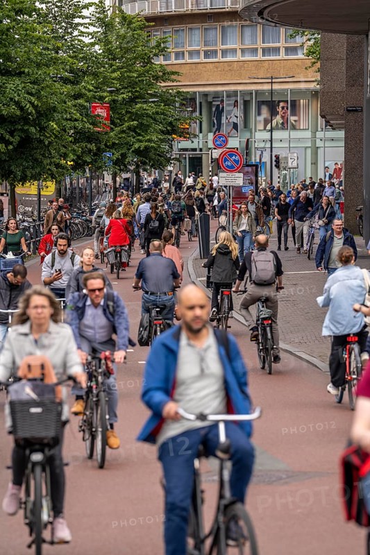 Central cycle path on the Lange Viestraat, in the centre of Utrecht, lanes for pedestrians, cyclists and cars are separated, heavy traffic, Netherlands