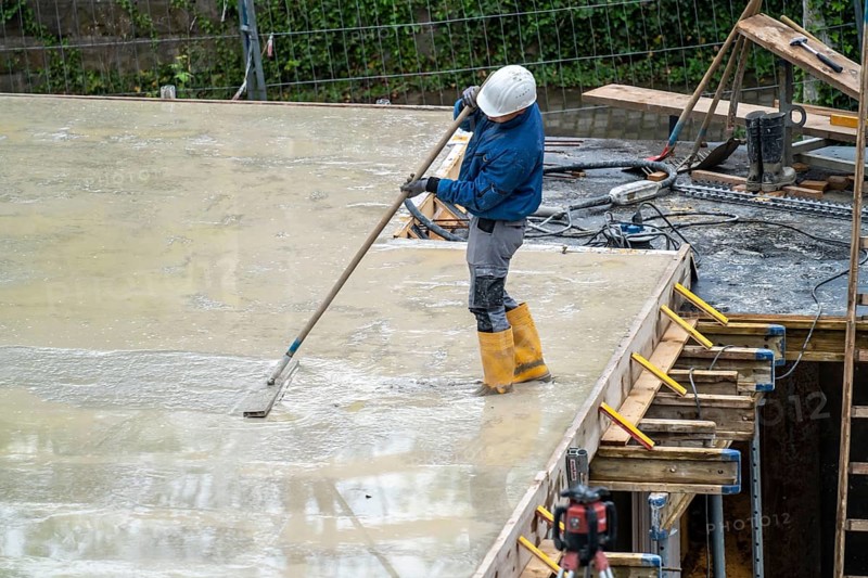 Construction site, concreting, the floor slab of a building is concreted, the fresh concrete is levelled