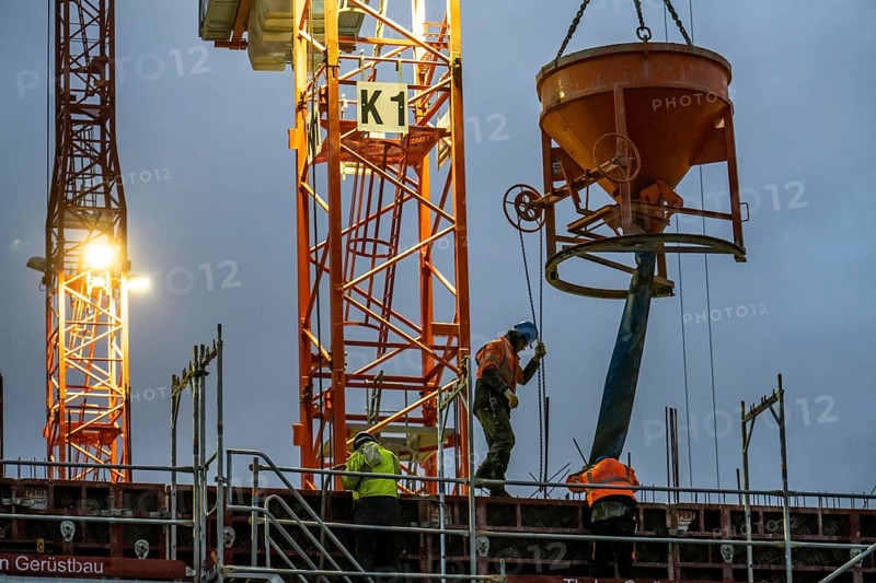 Concrete work, at dusk, on a large construction site building a residential and commercial complex, North Rhine-Westphalia, Germany, Europe