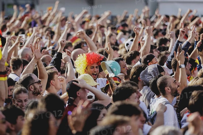 Fans react during the European Championship preliminary round match between Germany and Hungary on the fan mile in front of the Brandenburg Tor in Berlin, 19 June 2024