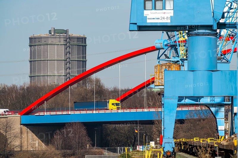 Gasometer of the Prosperität coking plant in Bottrop, cranes in Essen city harbour, motorway bridge of the A42 motorway, Emscher expressway, heavy goods traffic over the Rhine-Herne Canal, Essen North Rhine-Westphalia, Germany, Europe