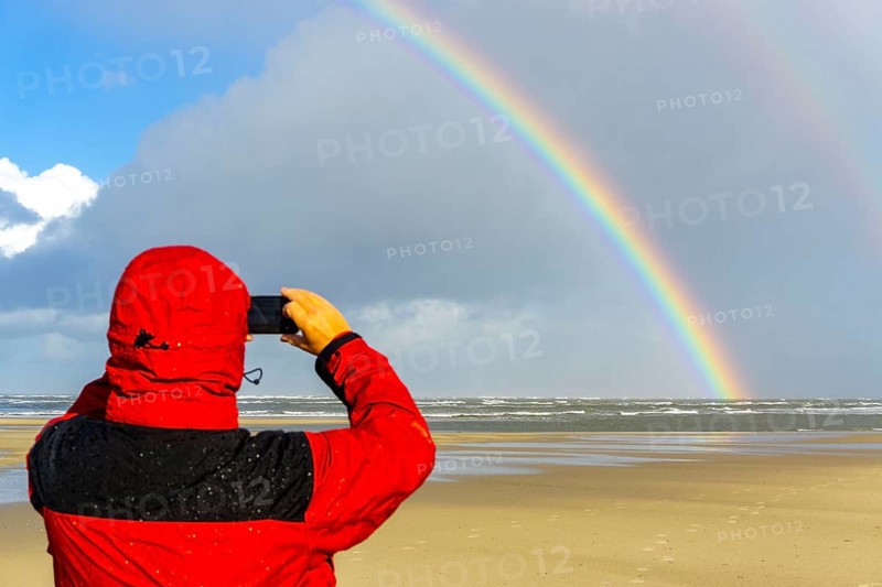 North Sea, Spiekeroog Island, autumn, rainy weather, with sun, rainbow, East Frisian Islands, beach walker take a photoLower Saxony, Germany, Europe