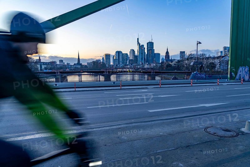Skyline of the city centre of Frankfurt am Main, cyclist on the raft bridge, dusk, river Main, winter, Hesse, Germany, Europe