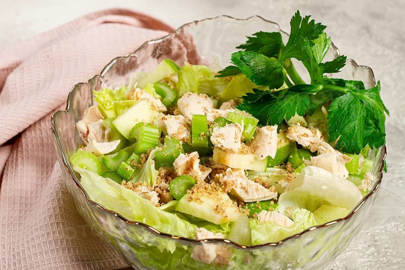 Waldorf salad, celery salad with apple, in a glass salad bowl, natural light, homemade, no people