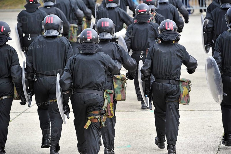 Demonstration of riot squad forming a protective barrier with riot shields during open day of the Belgian army at Leopoldsburg, Belgium, Europe