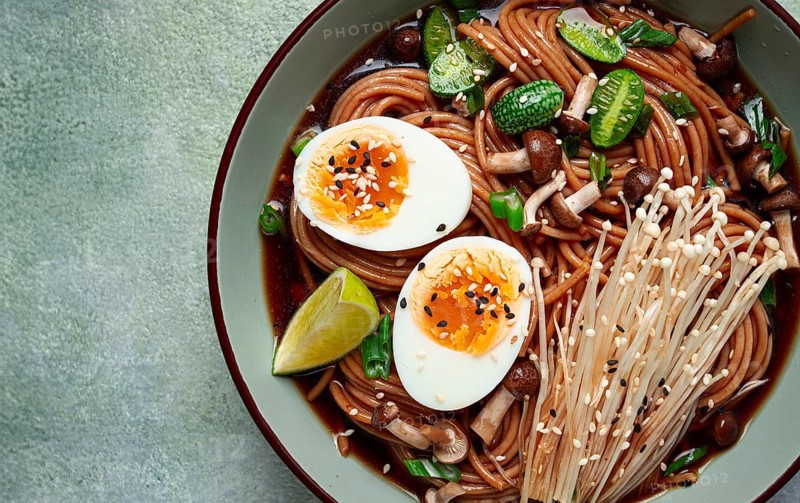 Soba, buckwheat noodles, with enoki mushrooms, shimeji and boiled egg, top view, homemade, no people