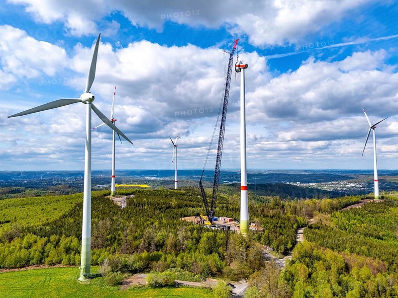 Erection of a wind turbine, wind energy plant, assembly of the ring generator, with a crawler lattice crane, wind farm near Hagen, North Rhine-Westphalia, Germany, Europe