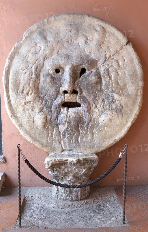The Bocca della Verita, Mouth of Truth is a disc-shaped relief, in the portico of the Santa Maria in Cosmedin church, Rome, Italy / Mouth of Truth, Bocca della Verita, a marble mask in the portico of the Santa Maria in Cosmedin church, Rome, Italy, Europe
