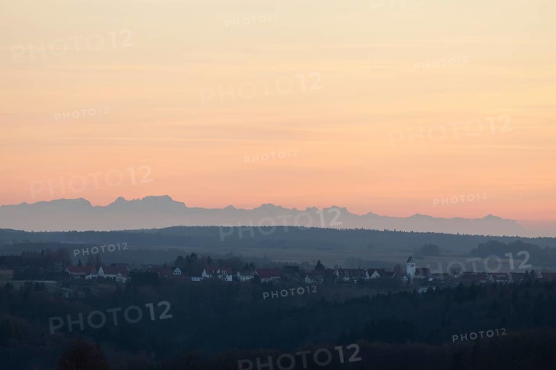 Alpine panorama near Magolsheim. Säntis, Swiss Alps at cloudless sunset with a view of Mehrstetten. View from the Alpenblick tower