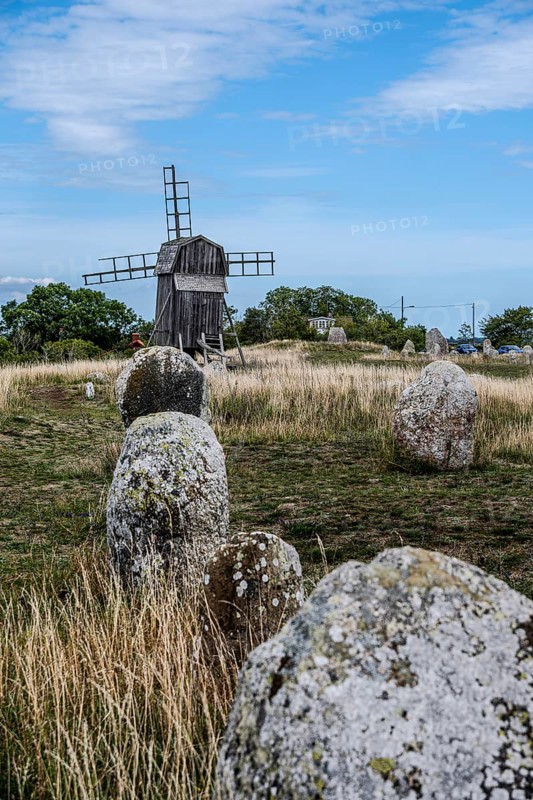 Stone settlement and traditional windmill at the cemetery of Gettlinge (Gettlinge gravfält), which was used from the Late Bronze Age to the Viking Age, in the south of the island of Öland, Kalmar län, Sweden, Europe