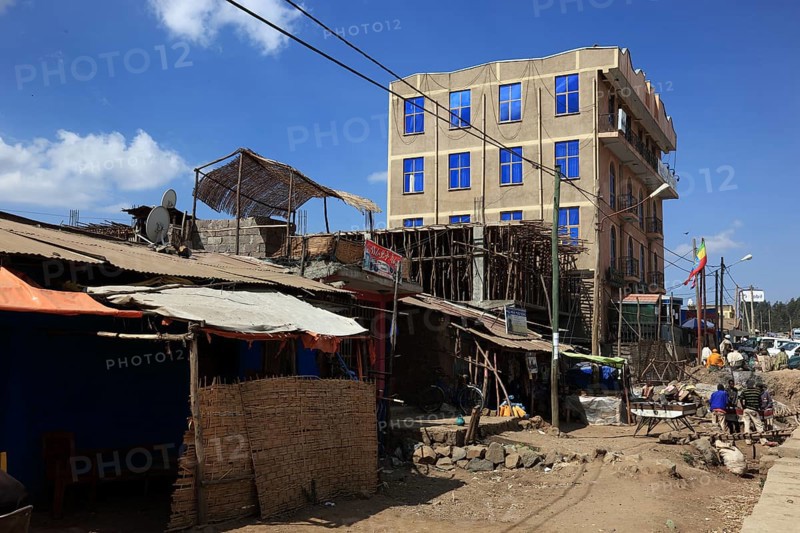 In the highlands of Abyssinia, in the Semien Mountains, Semien Mountains, village of Debark, modern building, hotel next to simple huts, Ethiopia, Africa