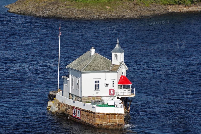 A lighthouse standing on a rock in the sea, with deep blue water and tranquil surroundings, restaurant, Dyna Fyr, Oslofjord, capital city, Oslo, Norway, Europe