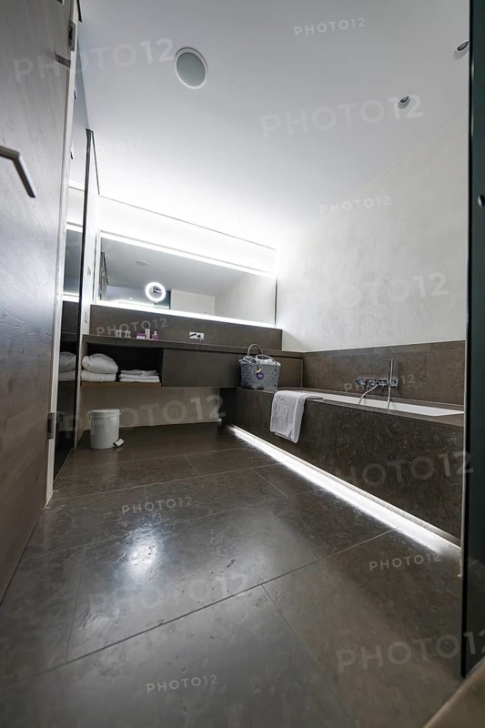 Modern bathroom with large shower, bathtub and illuminated mirror, Mayrhofen, Zillertal, Austria, Europe