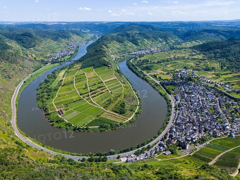 A river meanders through a green, hilly landscape with vineyards and a neighbouring village, surrounded by arable land, aerial view, Moselle, Moselle bend, Bremm, Cochem, Cochem-Zell, Rhineland-Palatinate, Germany, Europe
