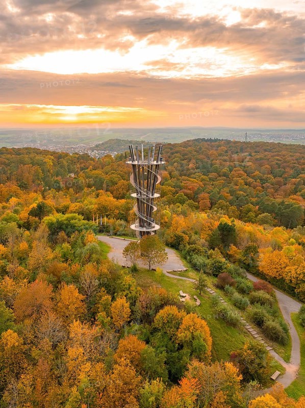 The observation tower stands majestically above the autumnal forest in a sea of colour, Schönbuchturm, Herrenberg, Germany, Europe
