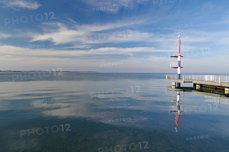 View of calm sea with jetty and cloudy sky, peaceful atmosphere, Rechlin, Müritz, Mecklenburg-Vorpommern, Germany, Europe
