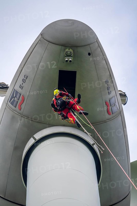Height rescuers from the Gelsenkirchen fire brigade practise abseiling from a wind turbine from a height of 110 metres after rescuing an accident victim from the nacelle, Gladbeck, North Rhine-Westphalia, Germany, Europe