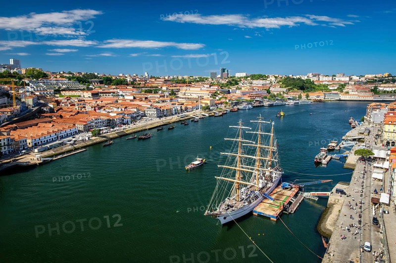 Aerial view of Porto city and Vila Nova de Gaia and Douro river with moored sailling ship from Dom Luis bridge I. Porto, Portugal, Europe