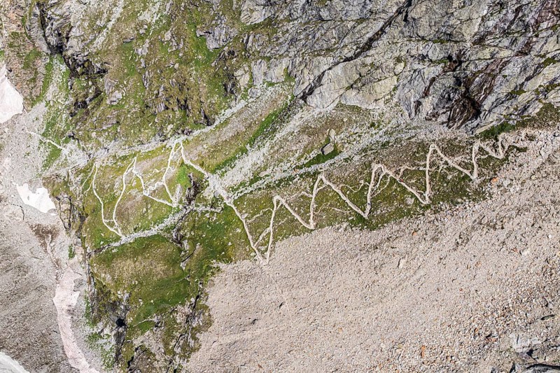 Serpentines of hiking trail up to mountain hut Cabane de Moiry, aerial view, Valais, Switzerland, Europe