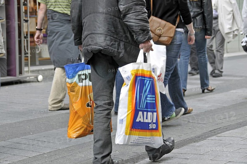 Old man after shopping at the discounters: plus and Aldi-Süd, pedestrian zone in Cologne, North Rhine-Westphalia, Germany, Europe