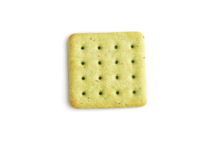 Green cracker pile isolated on white background. top view, flat lay, close up