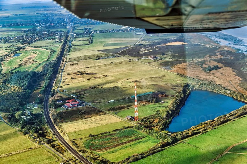 Railway tracks lead through meadows and fields, Morsum Teich Nösse Kuhle and transmission mast, NDR radio station, aerial view, Sylt, Germany, Europe