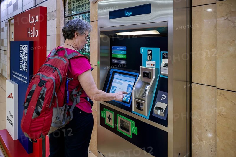 Interior shot, elderly woman, best ager at ticket machine, ticket terminal, Al Ras Station, train station, Dubai Metro, RTA, Dubai Creek, traffic, Dubai, United Arab Emirates, VAR, Asia