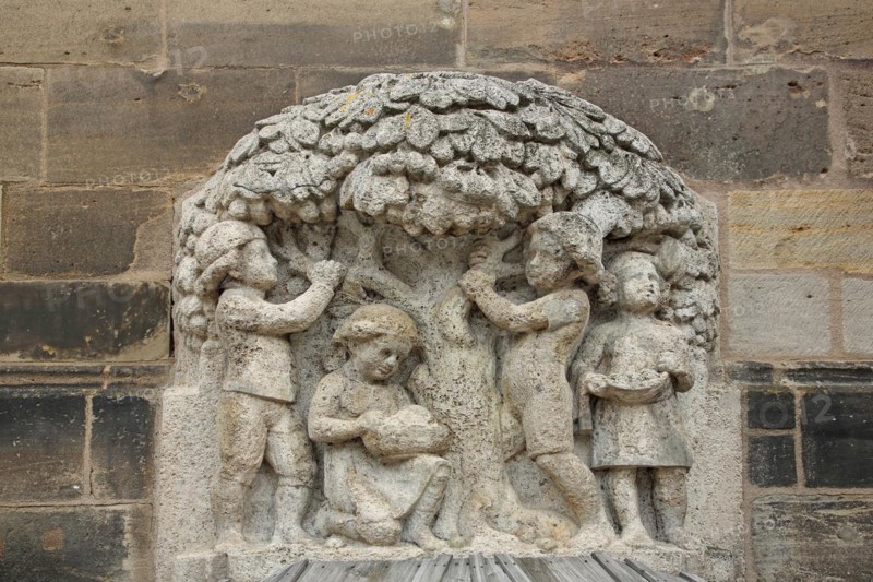 Sculpture Güllbrünnlein and monument to children's songwriter Friedrich Wilhelm Güll, St. Johannis Church, children's figures with tree, relief, stone, Ansbach, Middle Franconia, Franconia, Bavaria, Germany, Europe